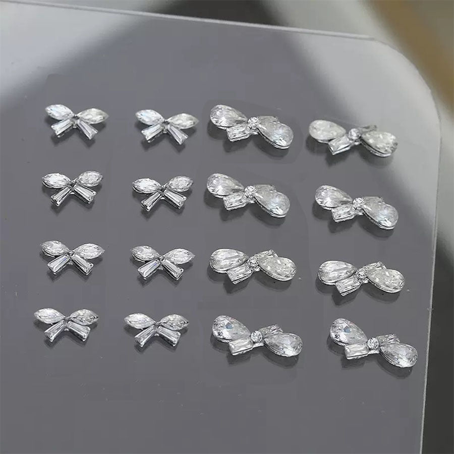 Metal alloy nail decoration with super shiny marquise-shaped water drop rhinestones and mini bow nail art accessories Secondary image